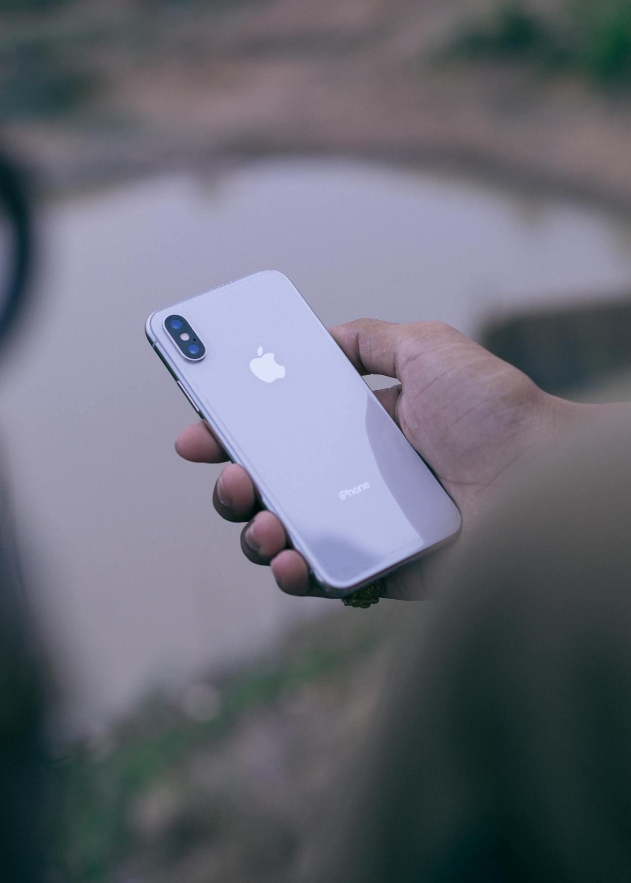 A person holding a smartphone in one hand